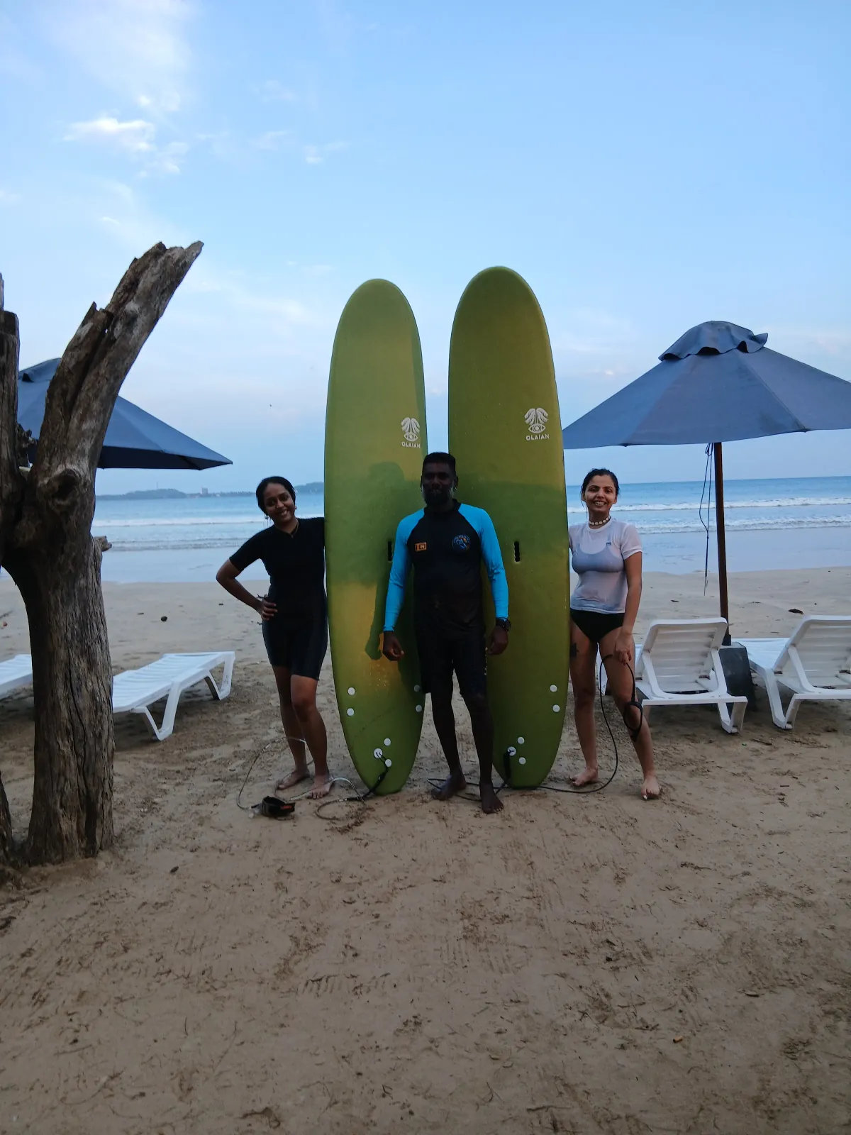 Beginner surf lesson group paddling out in Weligama Bay
